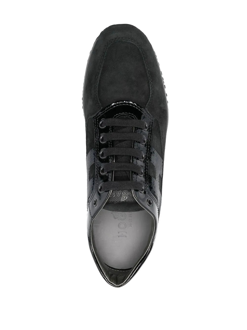Black lace-up sneaker top view with metal eyelets and smooth toe