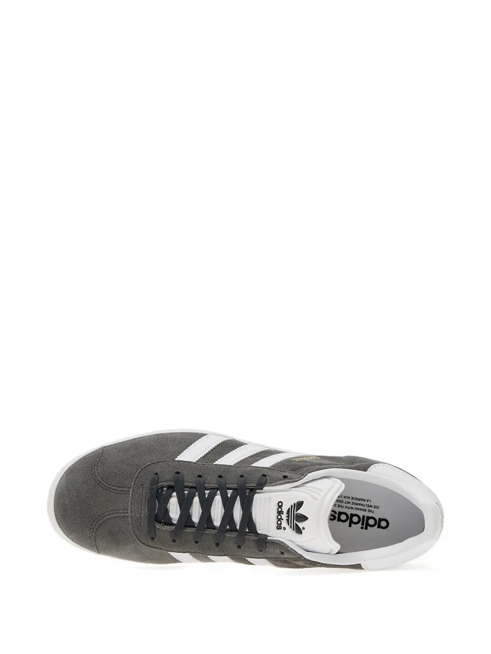 Side view of dark gray low-top sneakers with white stripes and lace-up