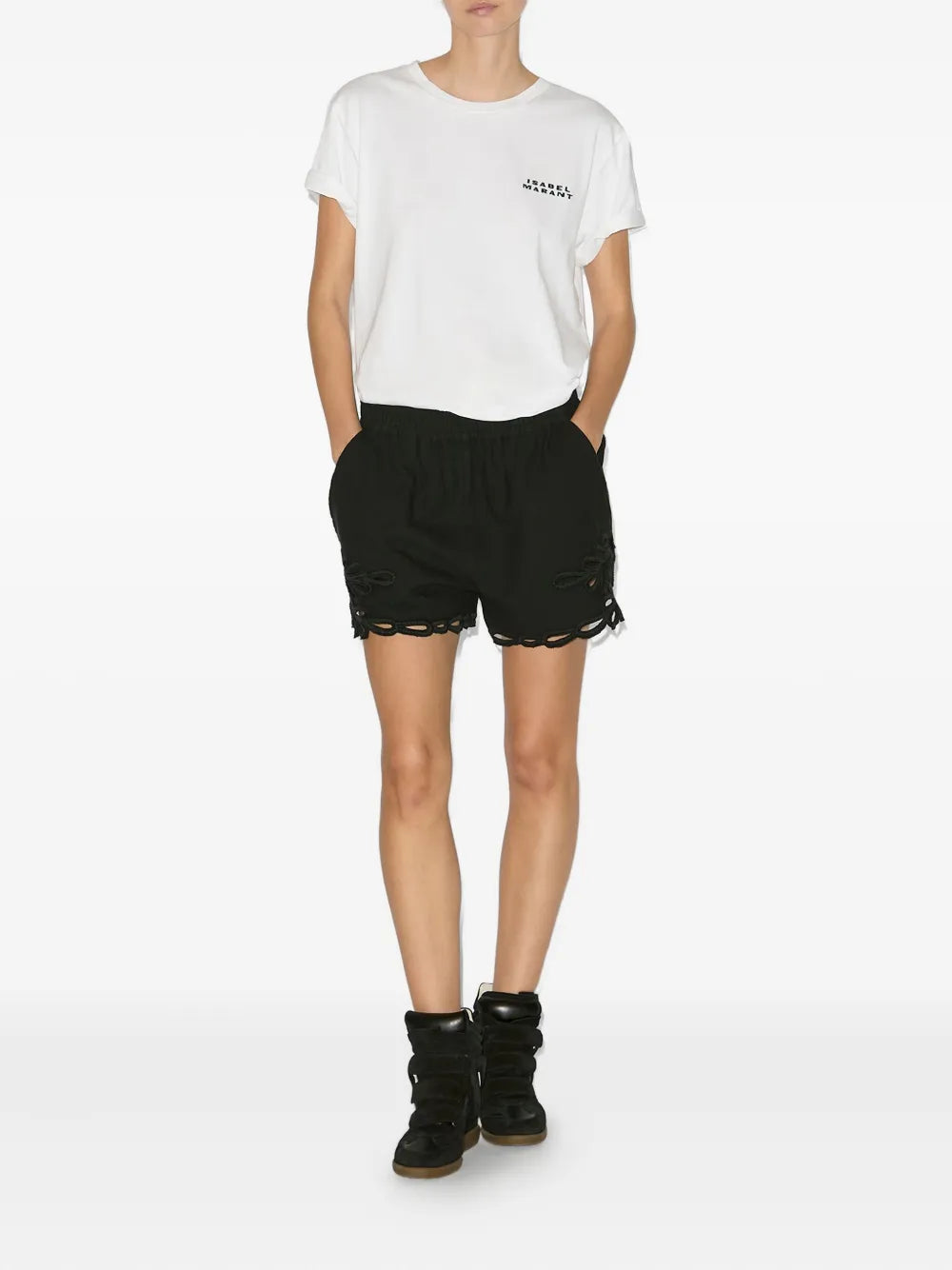 Black high-top sneakers worn with black shorts; double strap design and padded tongue