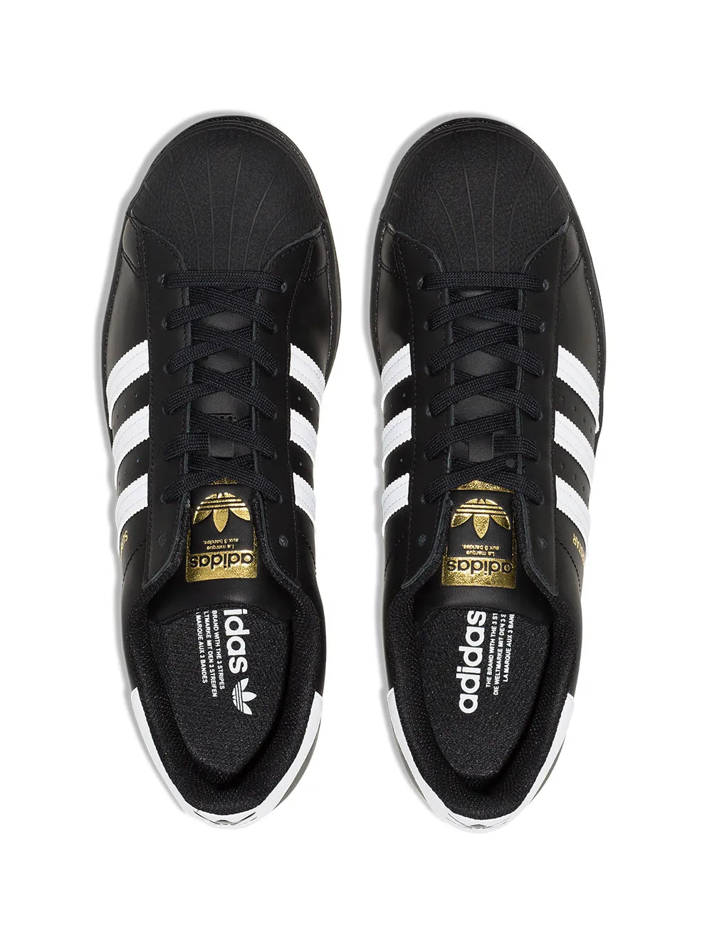 Pair of black adidas Superstar low-top sneakers with gold logo on insoles