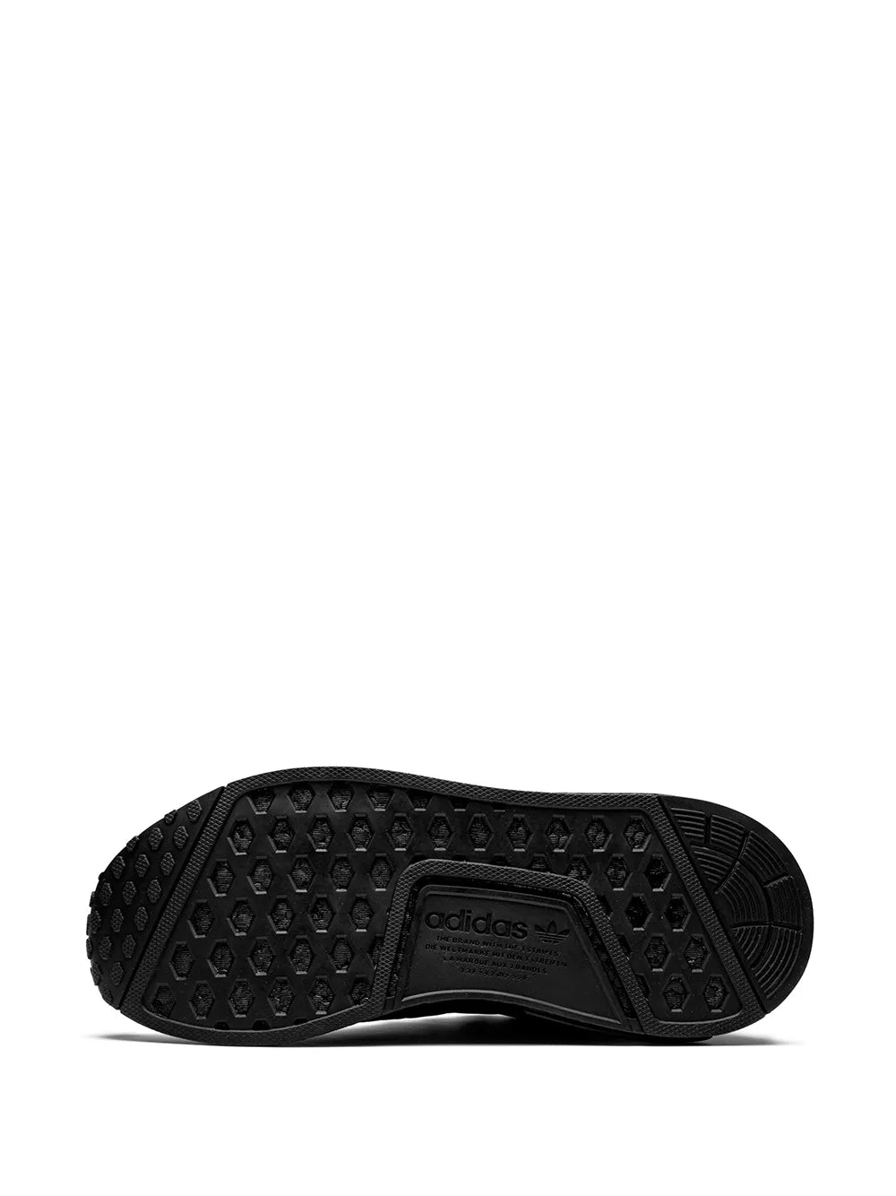 Black adidas NMD R1 sneaker outsole with circular traction tread pattern