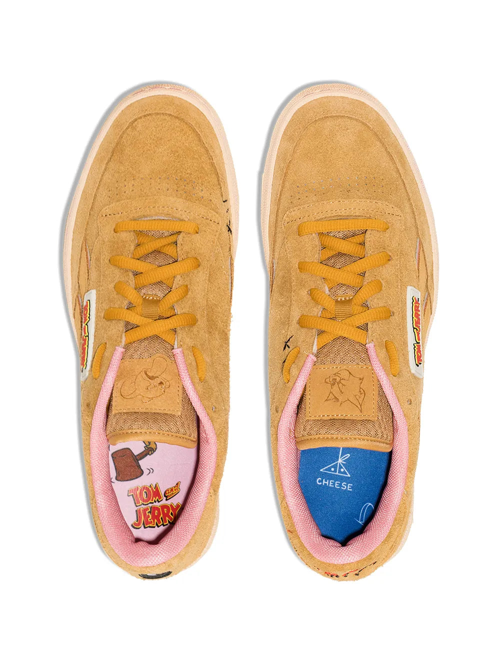 Tan suede low-top sneaker pair, yellow laces, pink tongue lining, white sole
