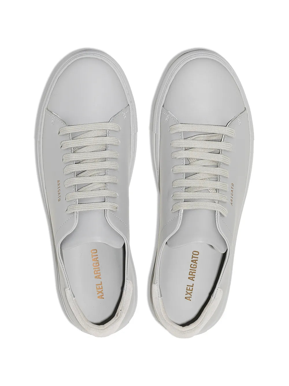 Pair of white low-top sneakers with lace-up closure and stitched panels