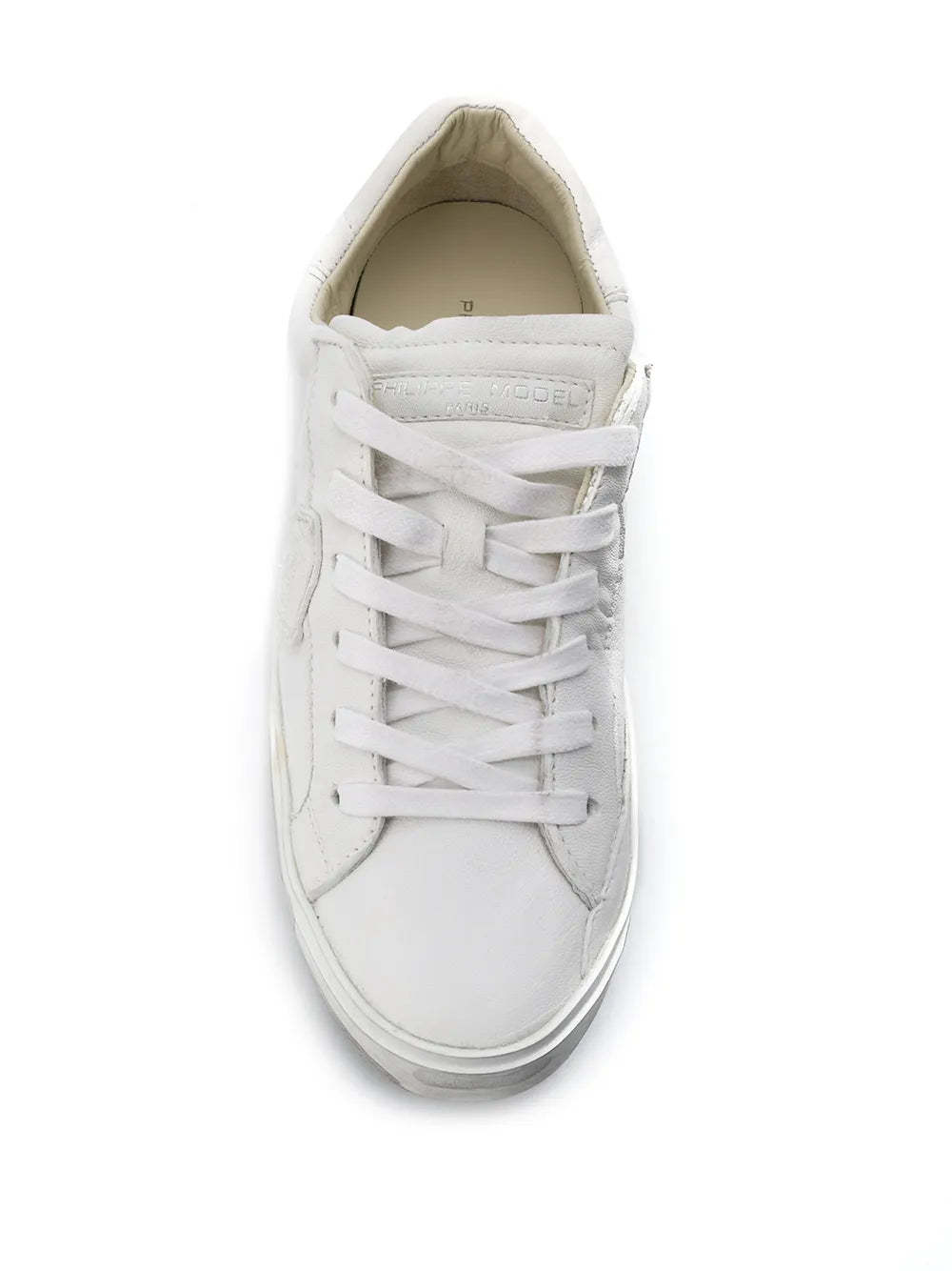 White low-top sneaker with flat laces and padded collar