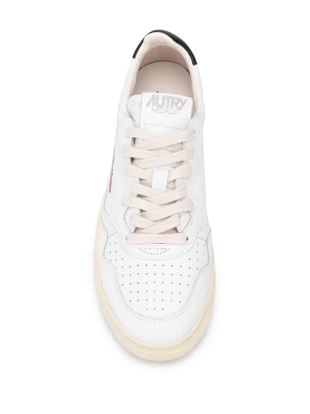 White leather lace-up sneakers with perforated toe and cream sole