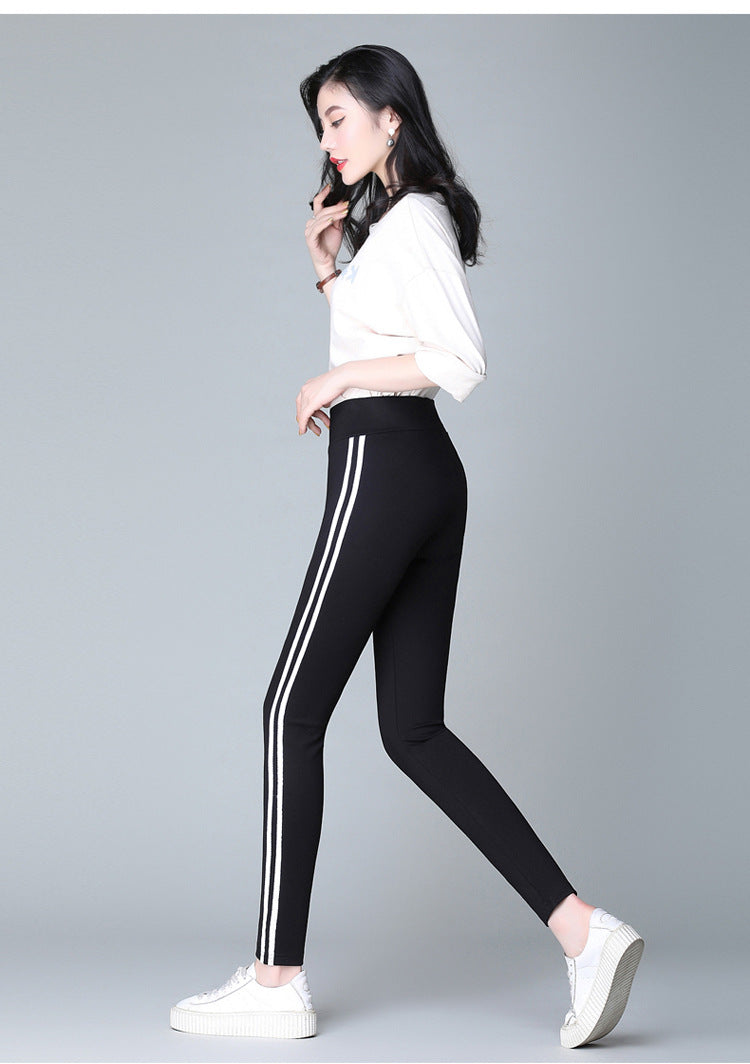 Black casual pants with white side stripe detailing, tapered leg and stretch waistband