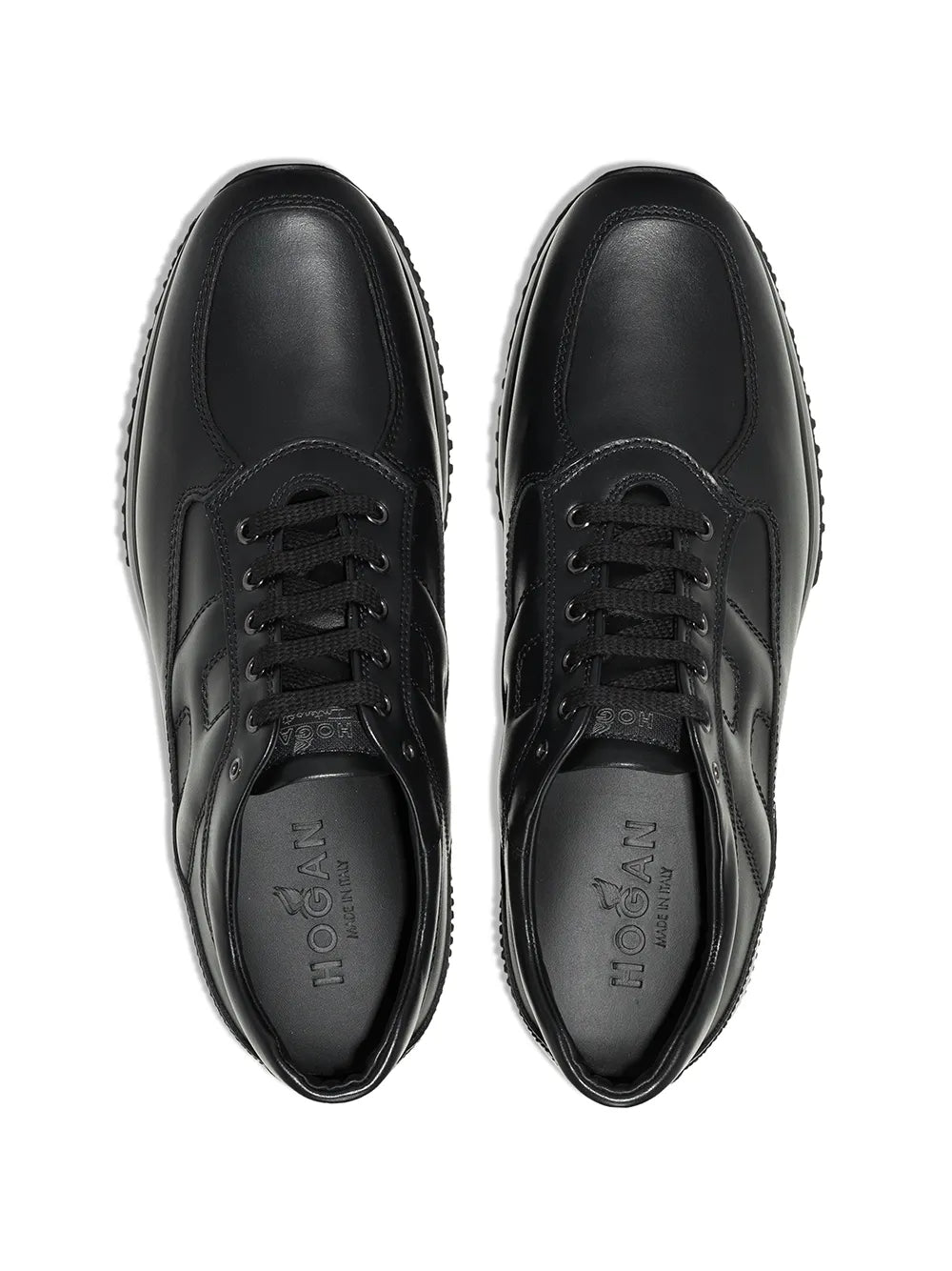 Black leather low-top sneakers, front view with lace-up and stitched toe caps