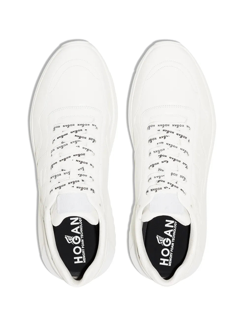 White low-top Hogan sneakers with printed insoles and tongue logos.