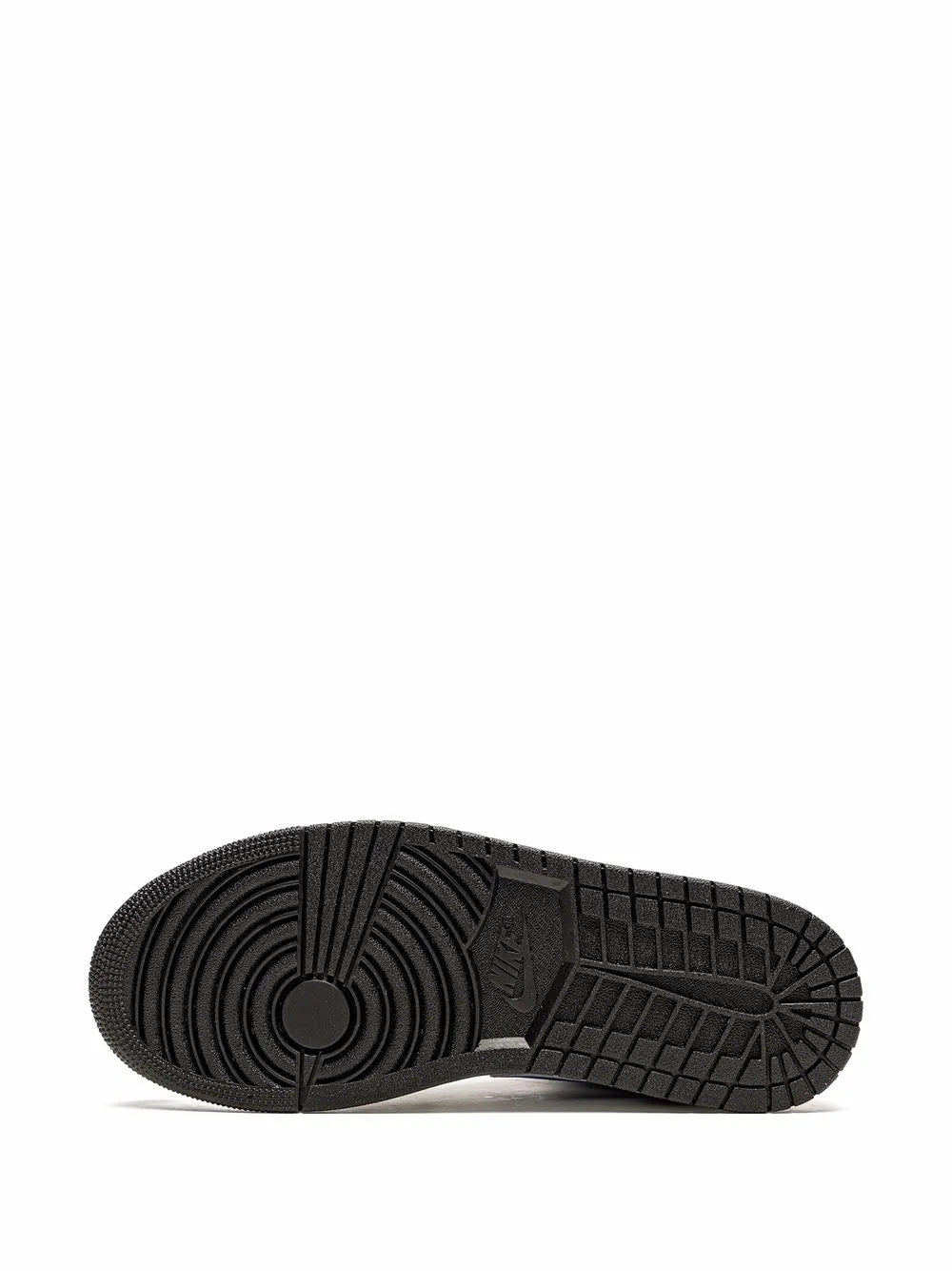 Black rubber outsole with tread pattern on mid-top sneakers