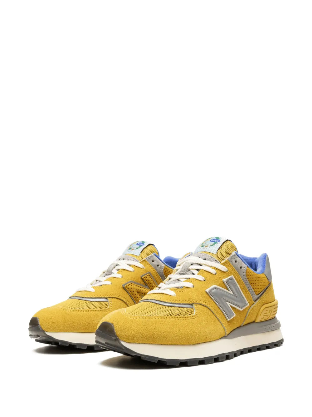 Front view of yellow New Balance 574 sneakers with gray N logos and white laces