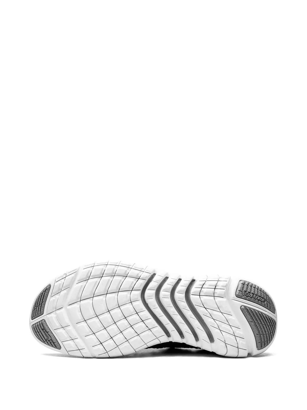 White rubber outsole with black traction pods and grid tread lines