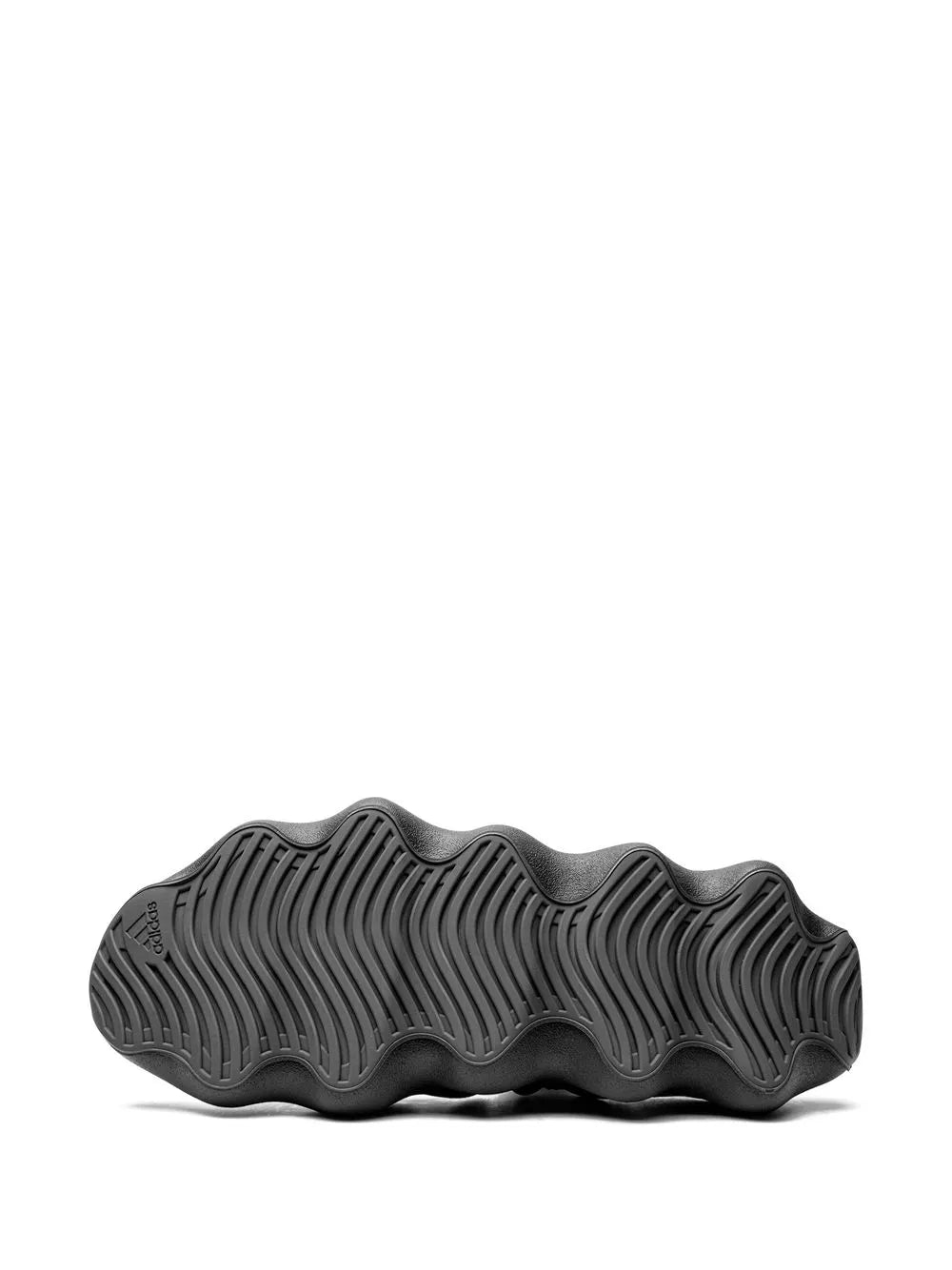 Black Yeezy 450 sneaker outsole with deep tread grooves for traction