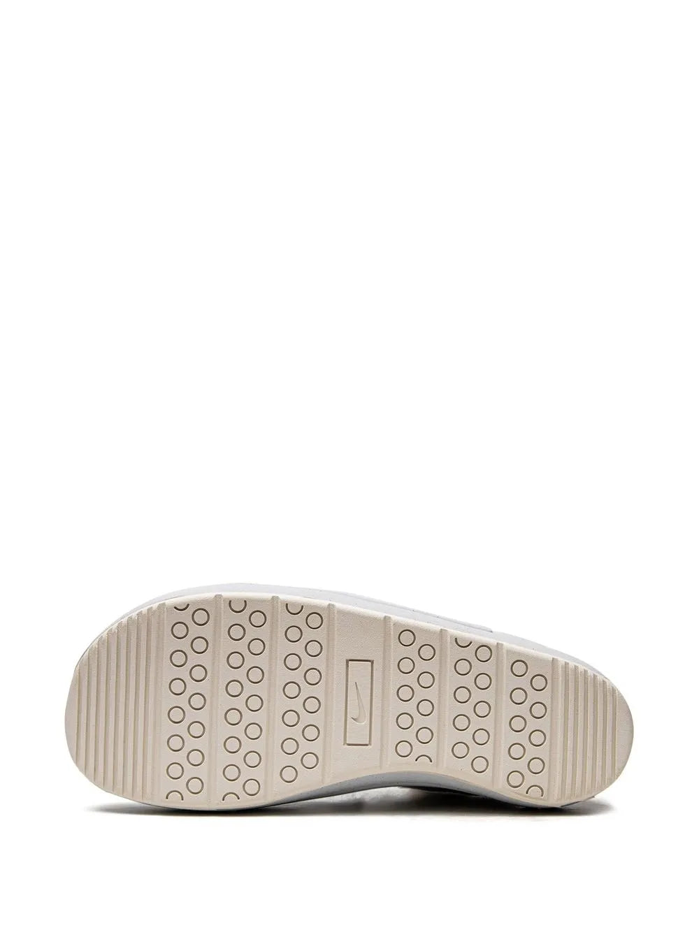 Light tan sneaker outsole with circular traction pattern