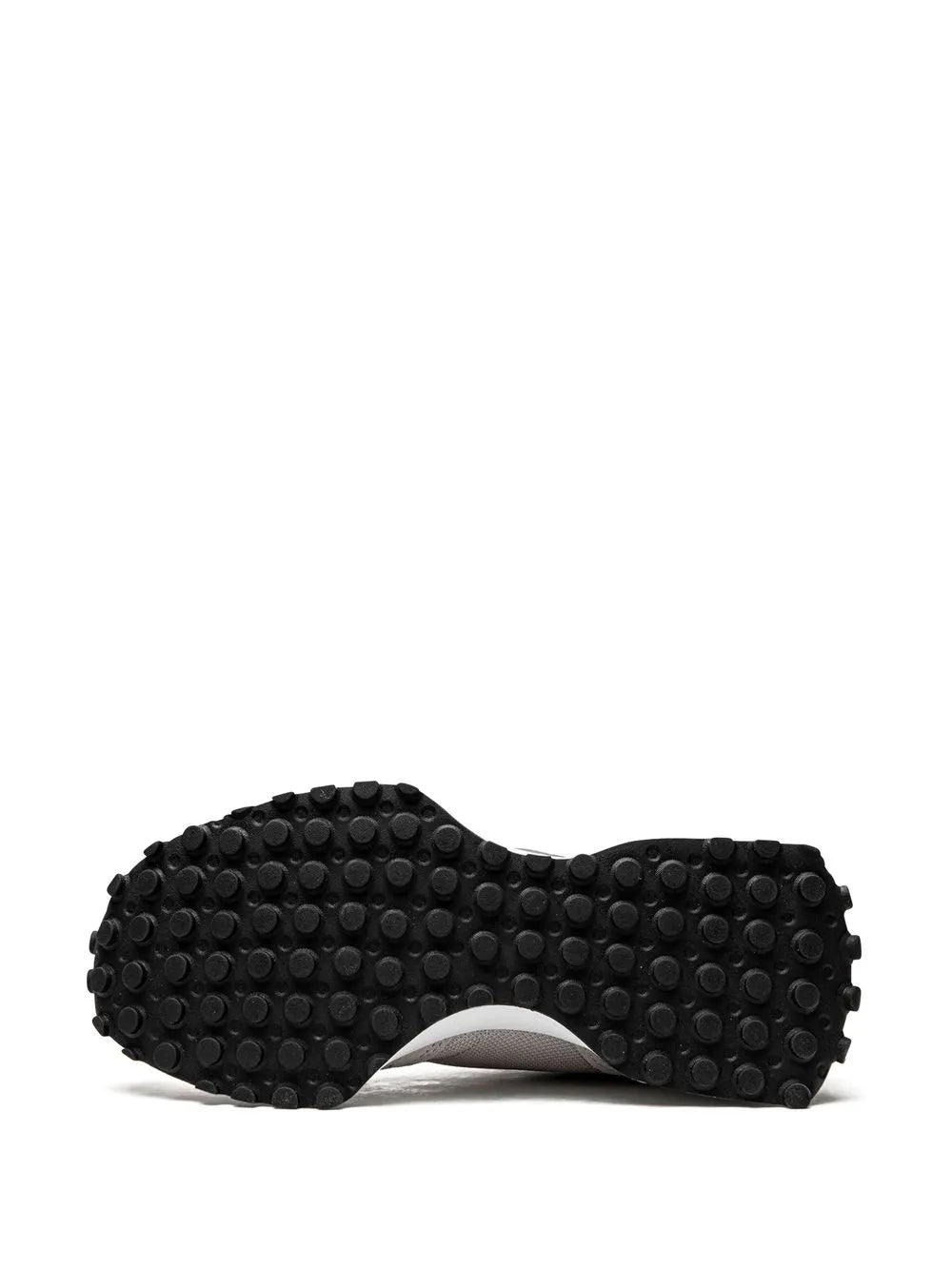 Gray outsole of sneakers with round nubs tread pattern and white midsole edge