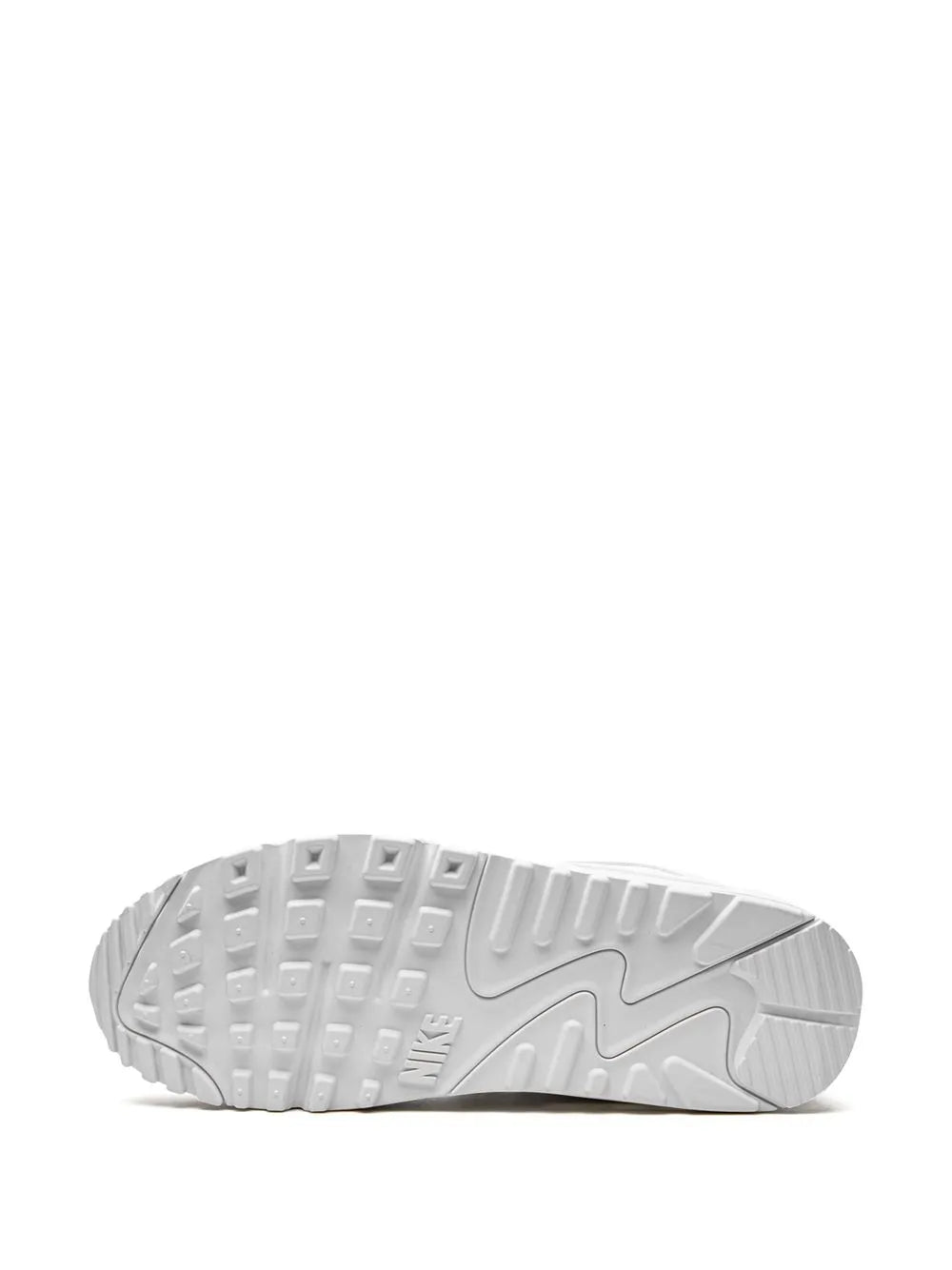 White sneaker outsole with deep tread and Nike logo patch