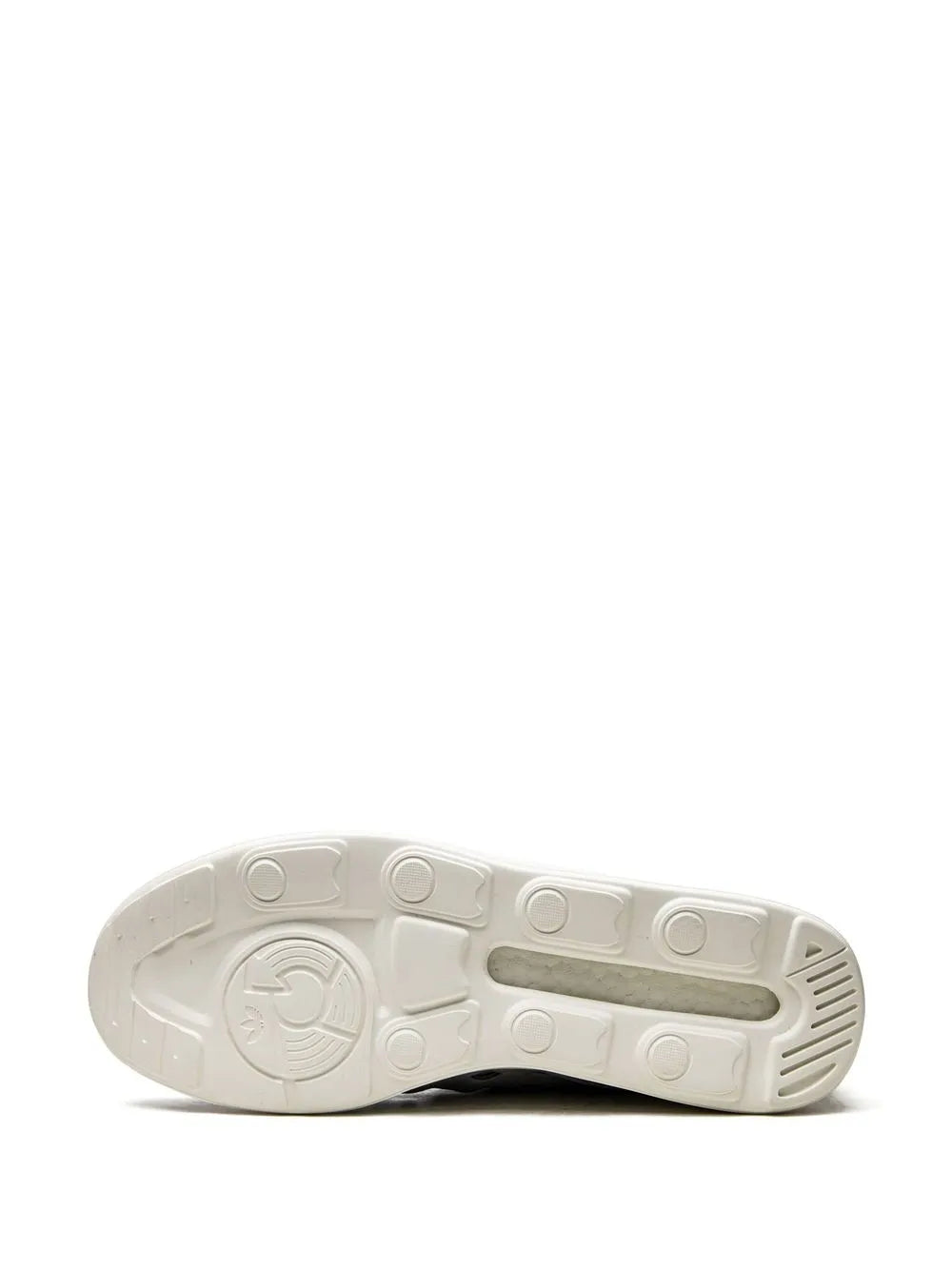 Grey outsole tread with circular logo and traction grooves
