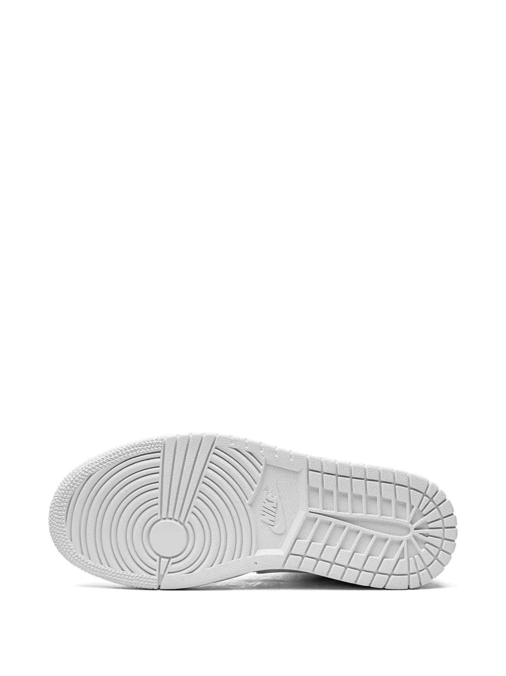 White sneaker outsole, patterned tread and circular logo on rubber sole