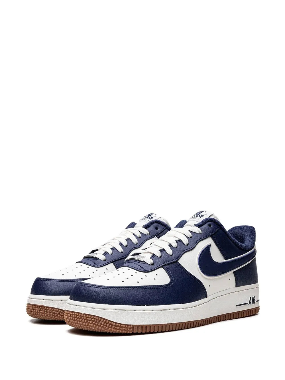 Nike low-top sneaker front view in navy and white with lace-up and gum sole