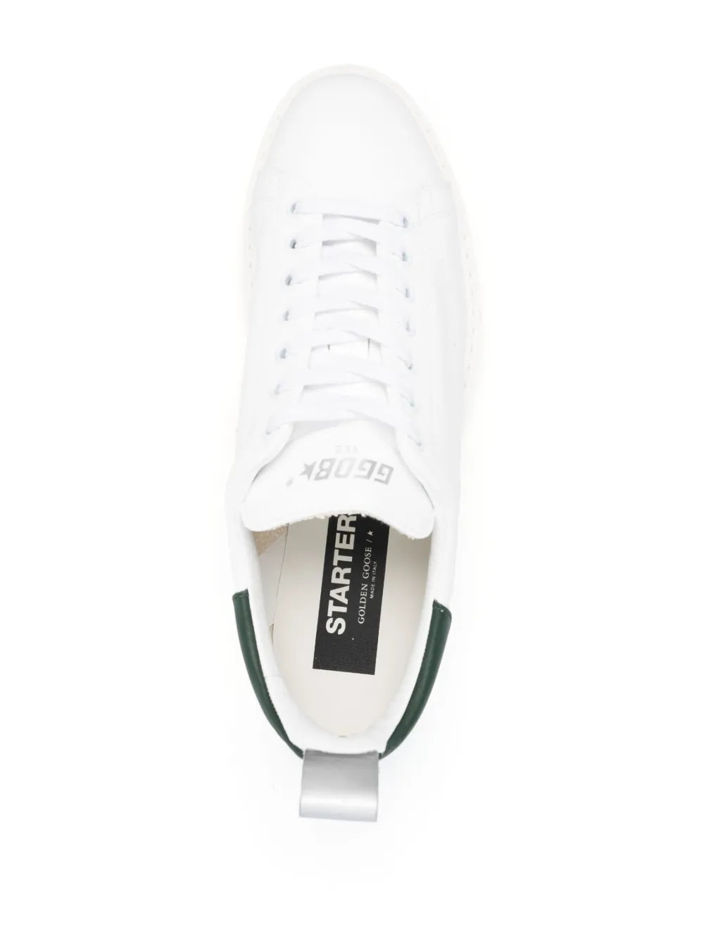 White low-top sneakers with green-lined interior and tongue label marked “STARTER”