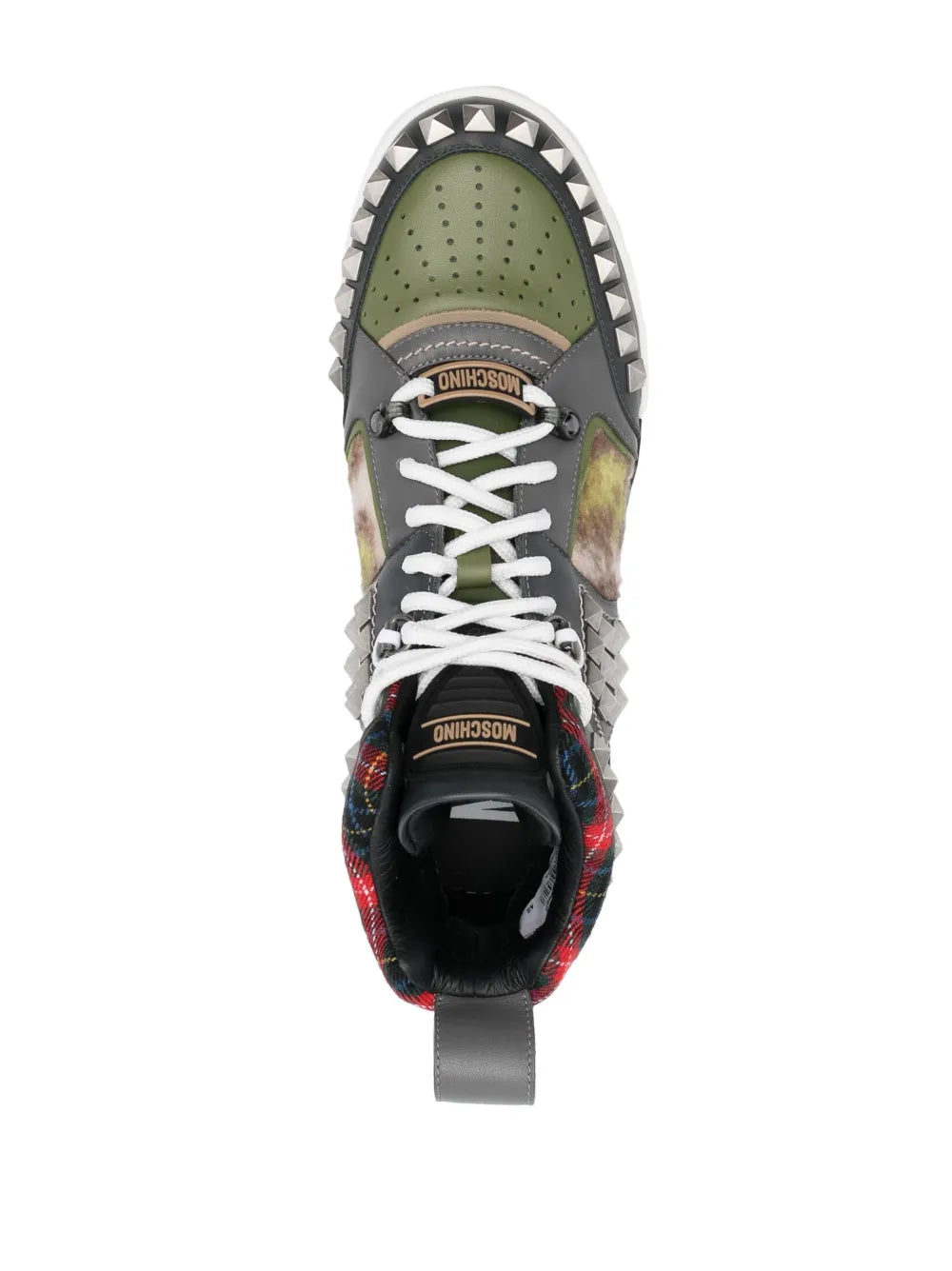 Studded sneaker toe view with perforated green panel and white laces, black heel lining