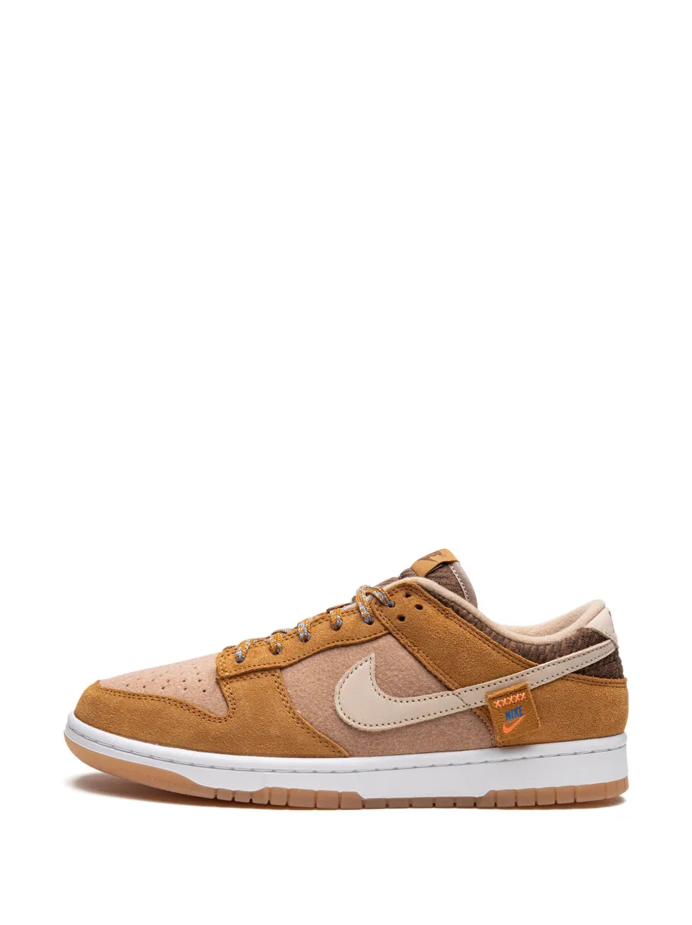 Nike Dunk Low SE lace-up sneaker with tan suede panels and white Swoosh.