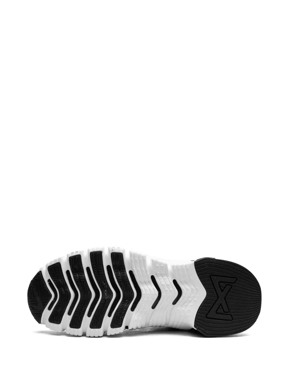 Nike Free Metcon 4 outsole view: black traction pods on white ribbed sole
