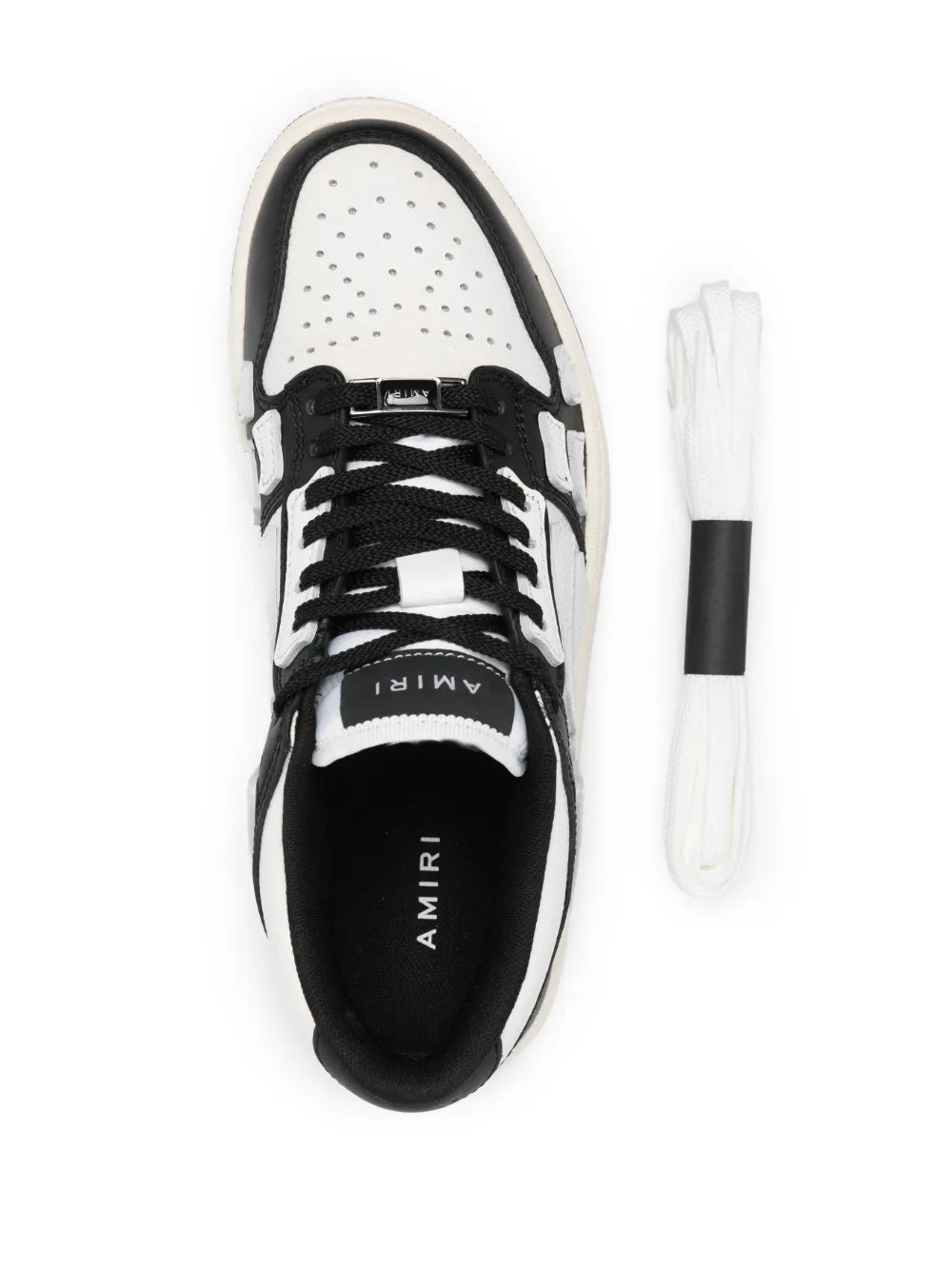 Black and white sneaker with lace-up, perforated toe box, and AMIRI branding