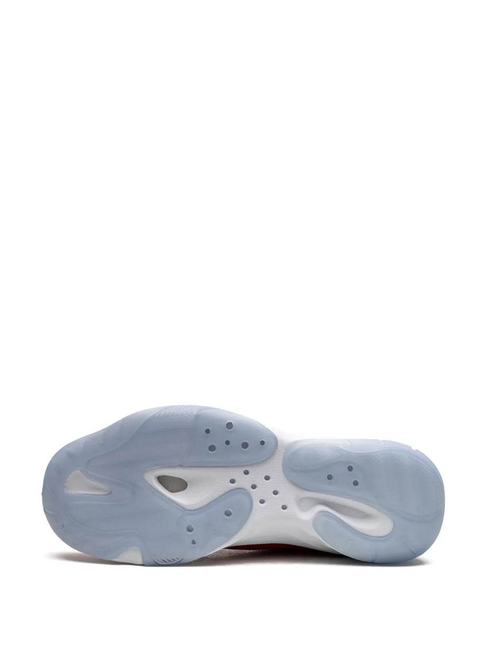 Red low-top sneaker outsole view with light tread pattern and pods