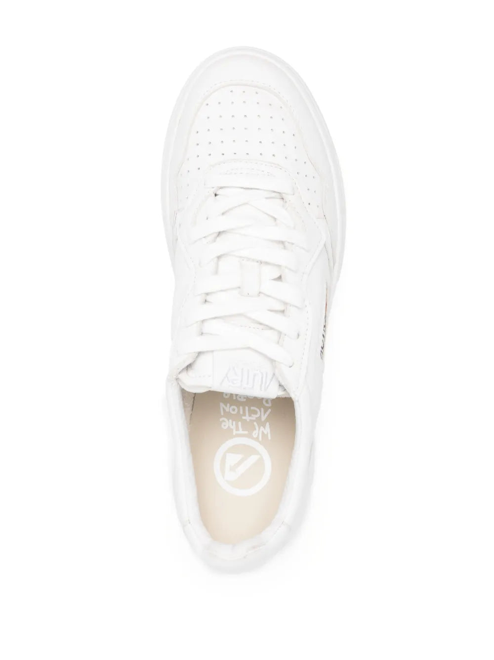 White low-top sneakers top view, lace-up with perforated toe and tongue tag