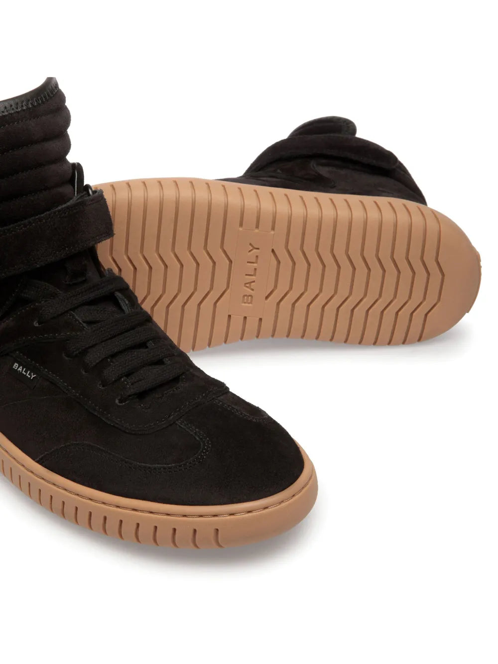 Black lace-up ankle boots showing treaded gum rubber sole and stitched eyelets
