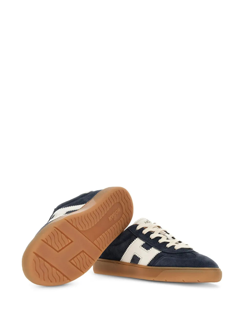 Navy leather sneakers with cream accents and gum rubber outsole underside