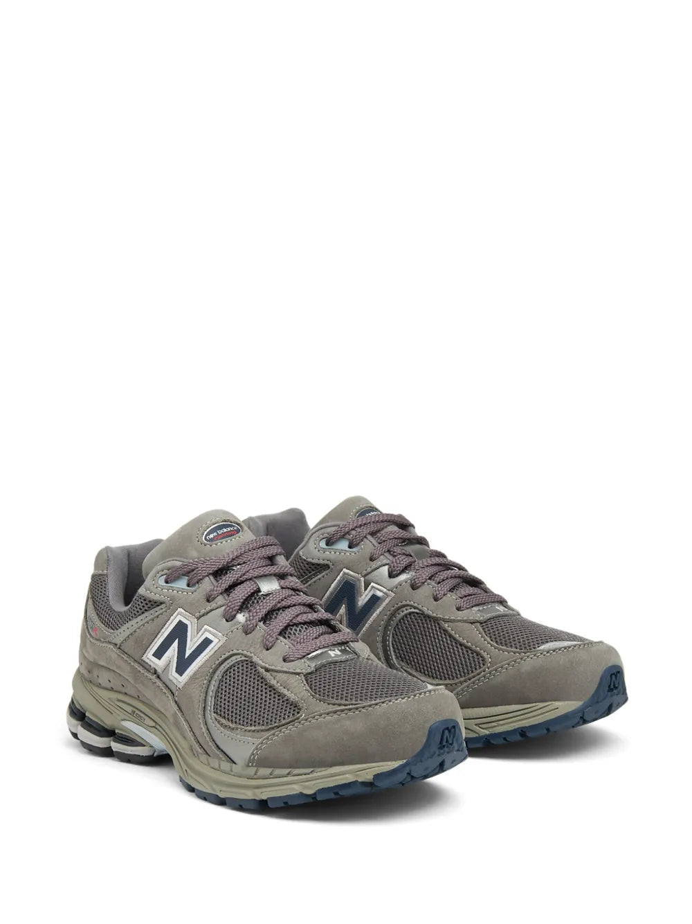 Ash grey New Balance 2002R sneakers, pair view with N logo and lace-up front