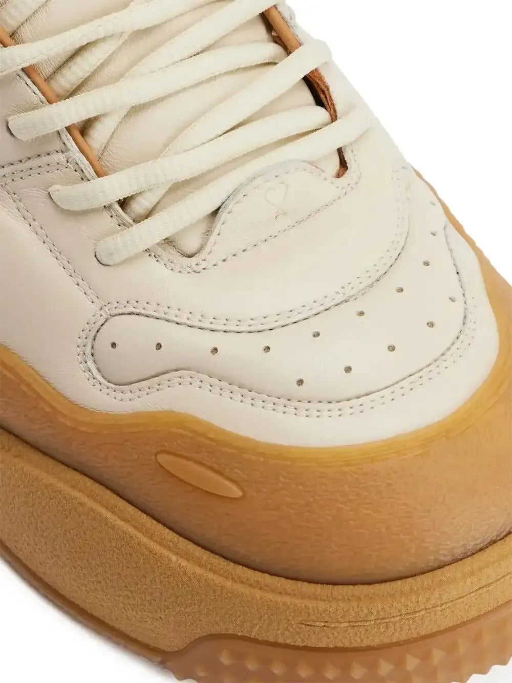 Ecru sneaker toe, laces, and perforations with tan sole detail