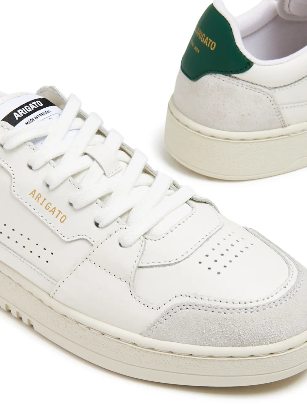 White leather lace-up sneaker detail with perforated toe and green heel lining
