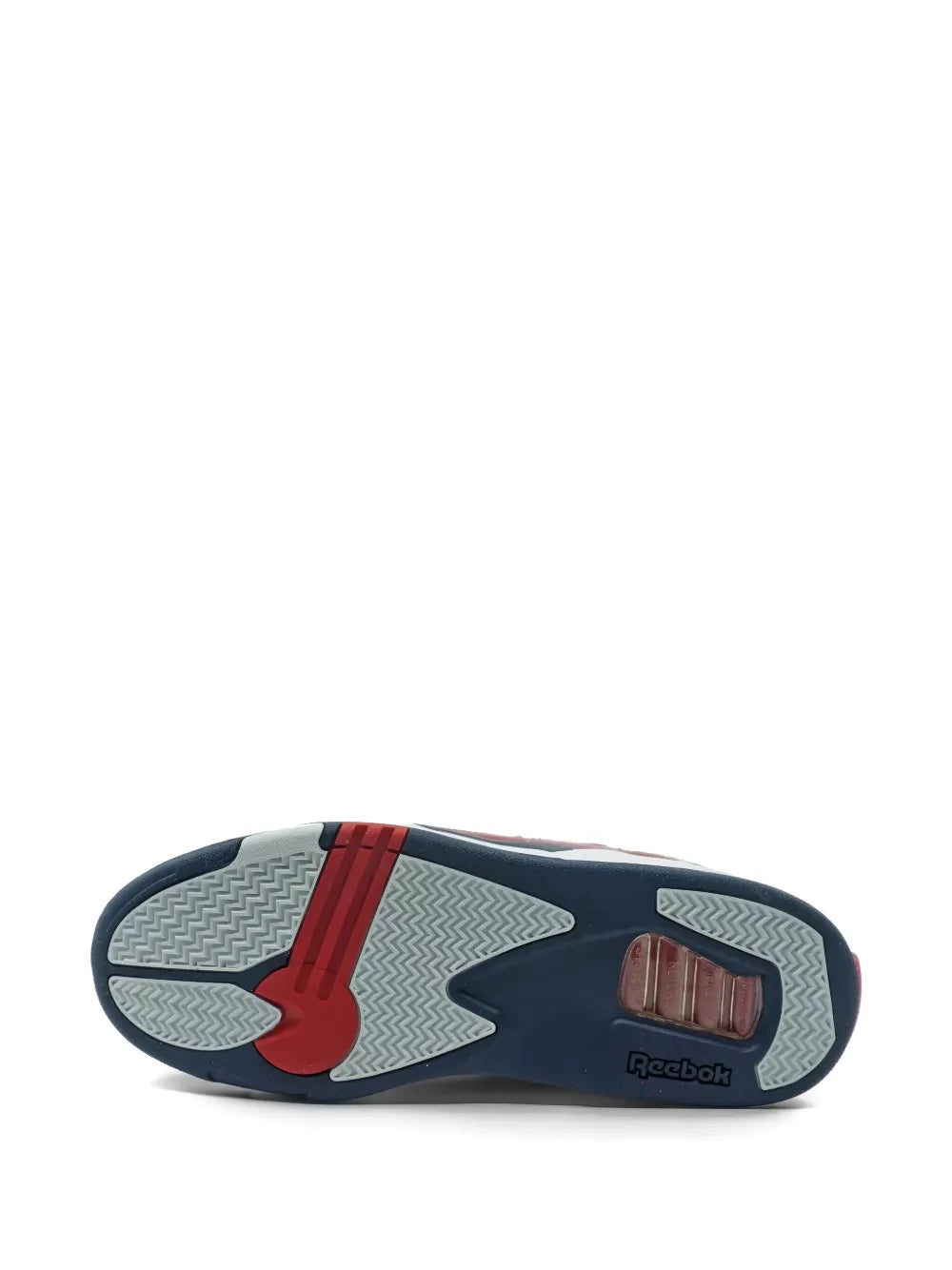 Bottom view of red Reebok high-top sneaker outsole with gray tread and blue heel