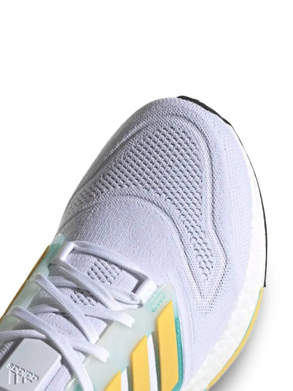 adidas Ultraboost 22 knit upper close-up with teal heel trim and yellow side stripes