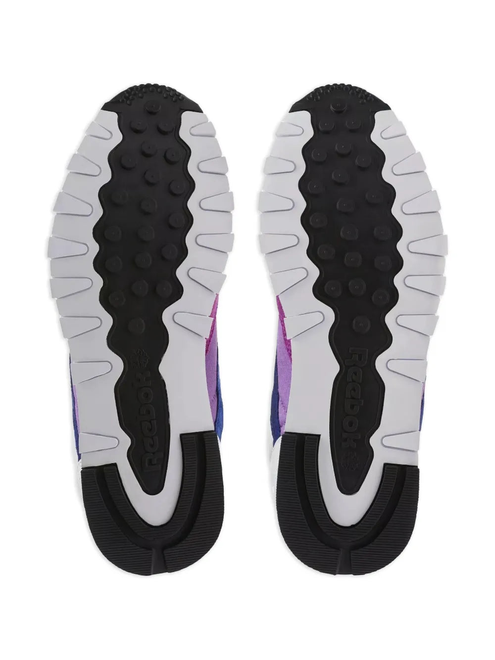 Reebok classic sneaker outsoles with textured tread, black midsoles and purple uppers