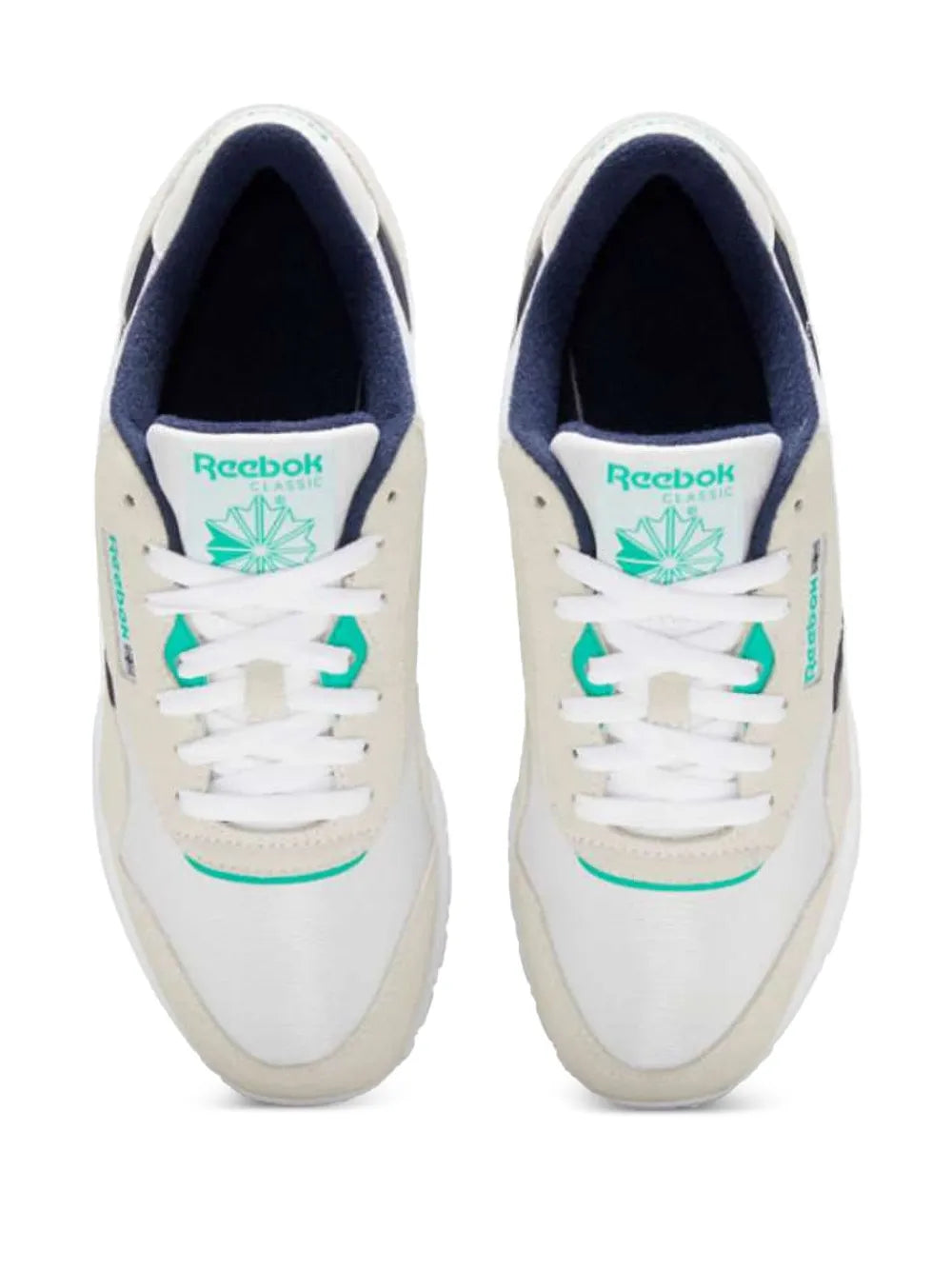 Beige and white low-top sneakers with teal Reebok badge and navy lining, lace-up