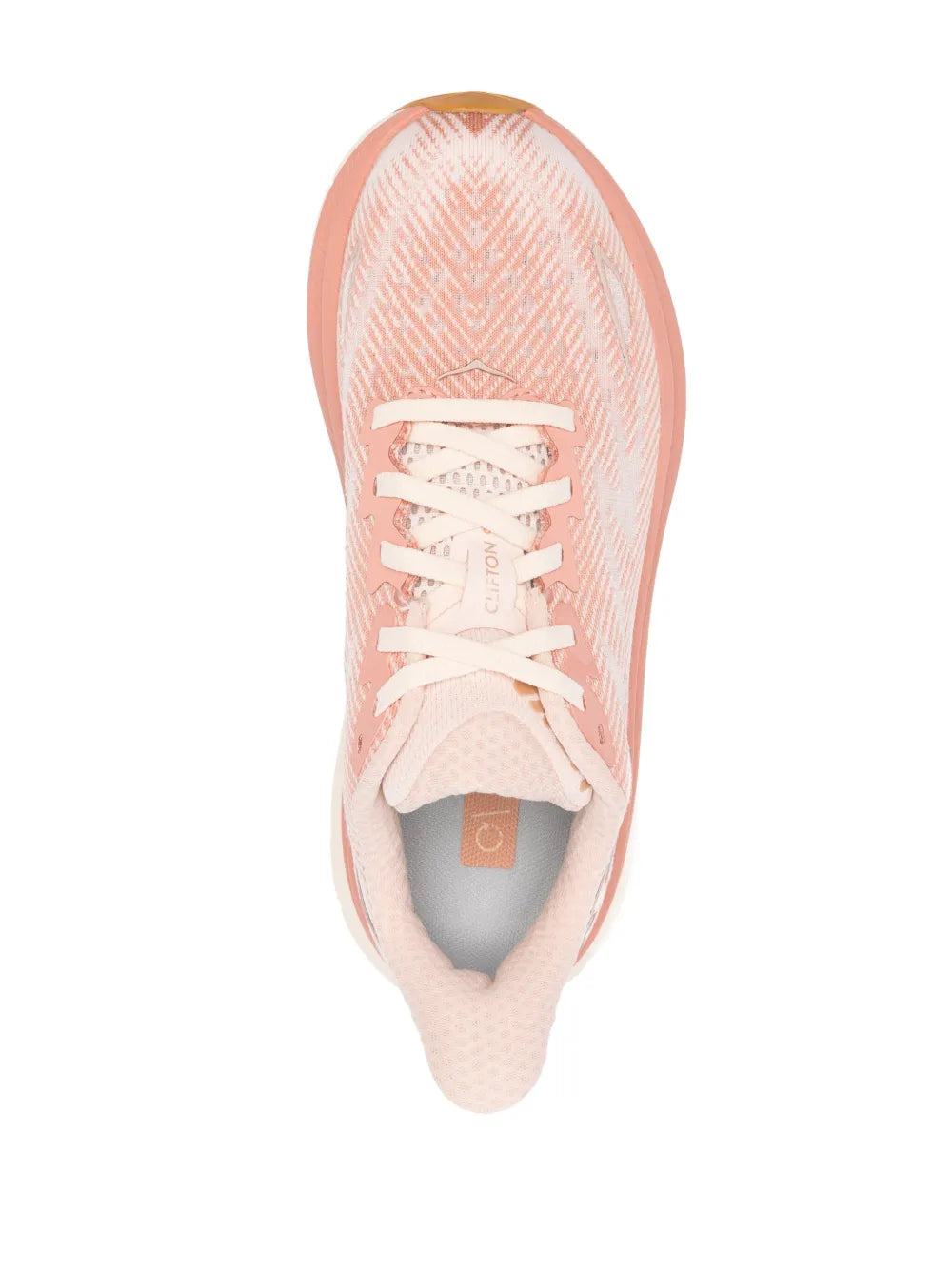 Peach HOKA running shoe upper close-up with white laces and interior lining