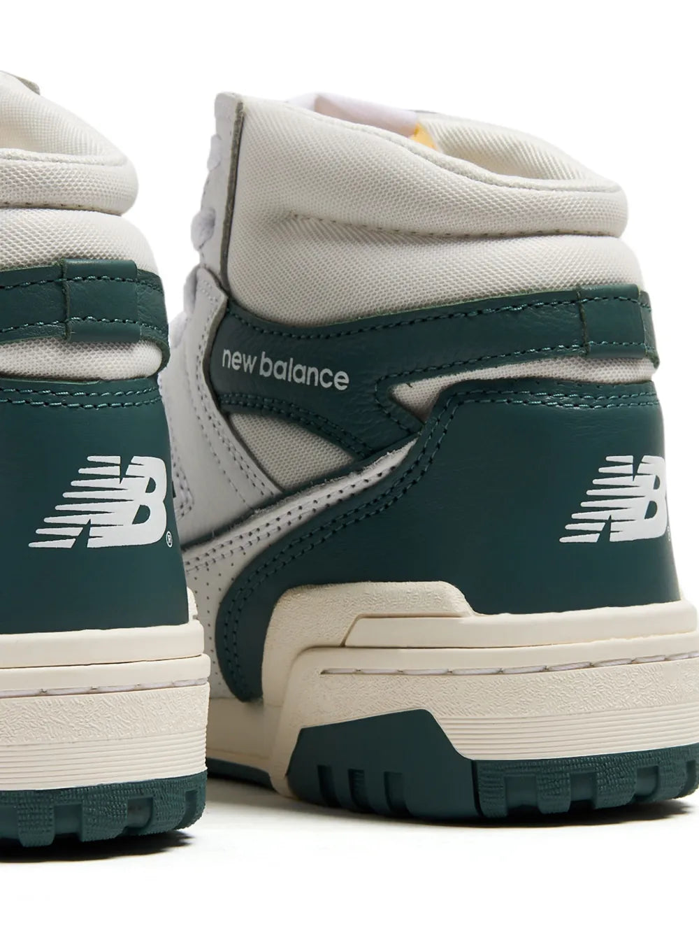 New Balance 650 high-top sneaker heel close-up, cream and dark green with lace panel