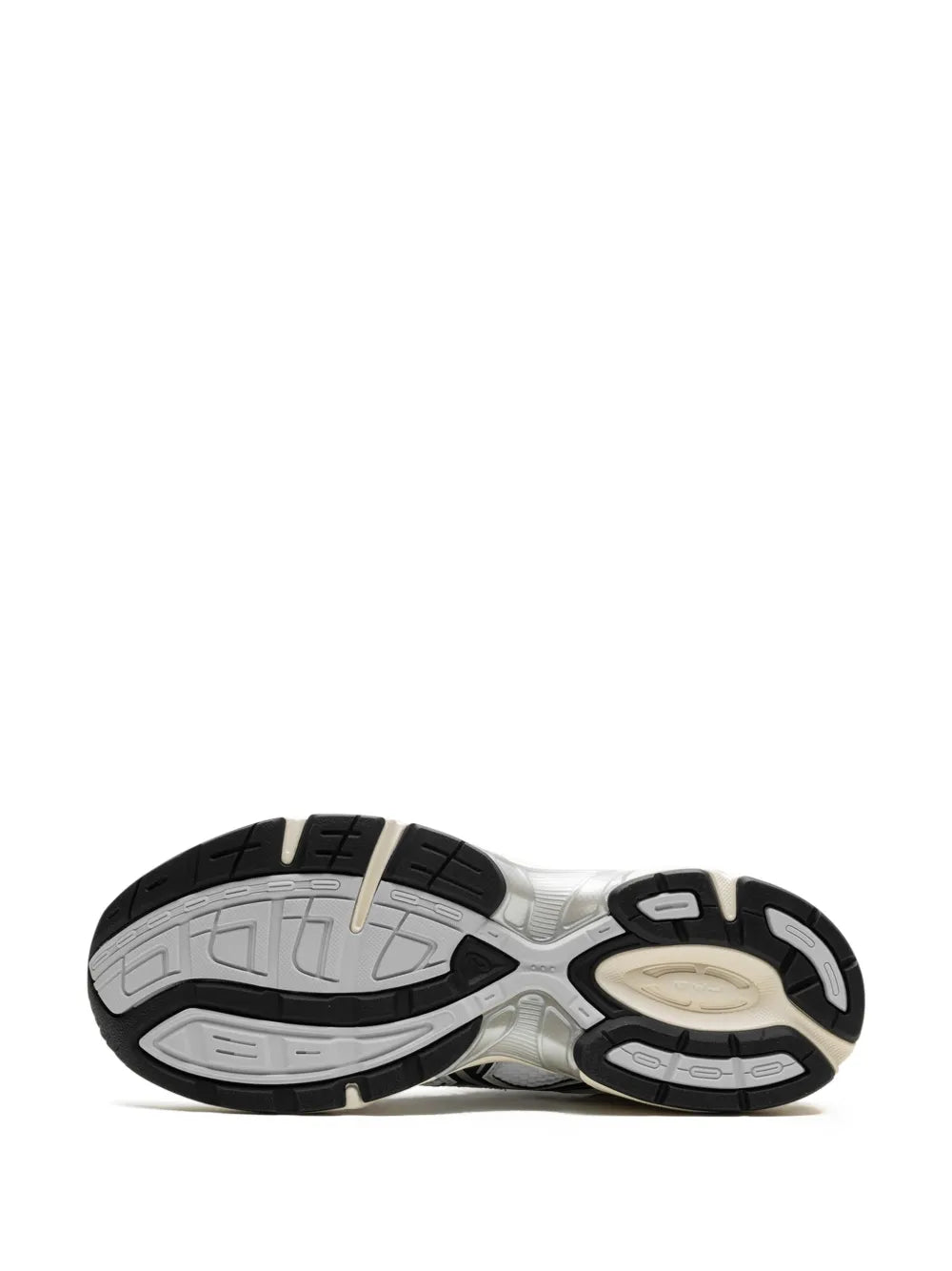 Outsole view of white Asics sneakers with black and beige traction pads