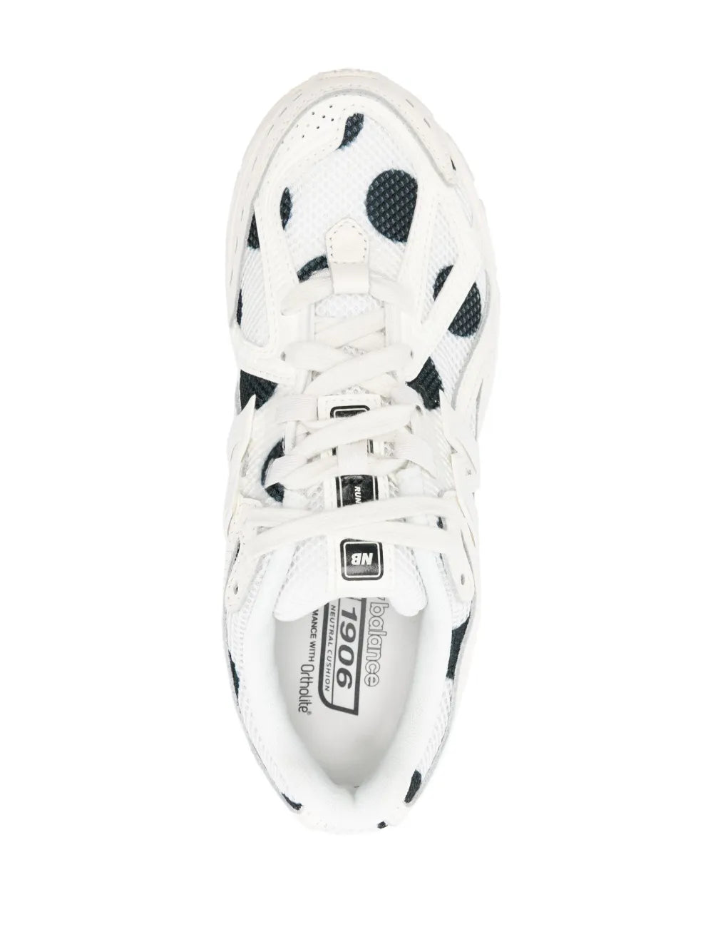 White New Balance 1906R sneaker top view, black polka-dot lining and 1906R label