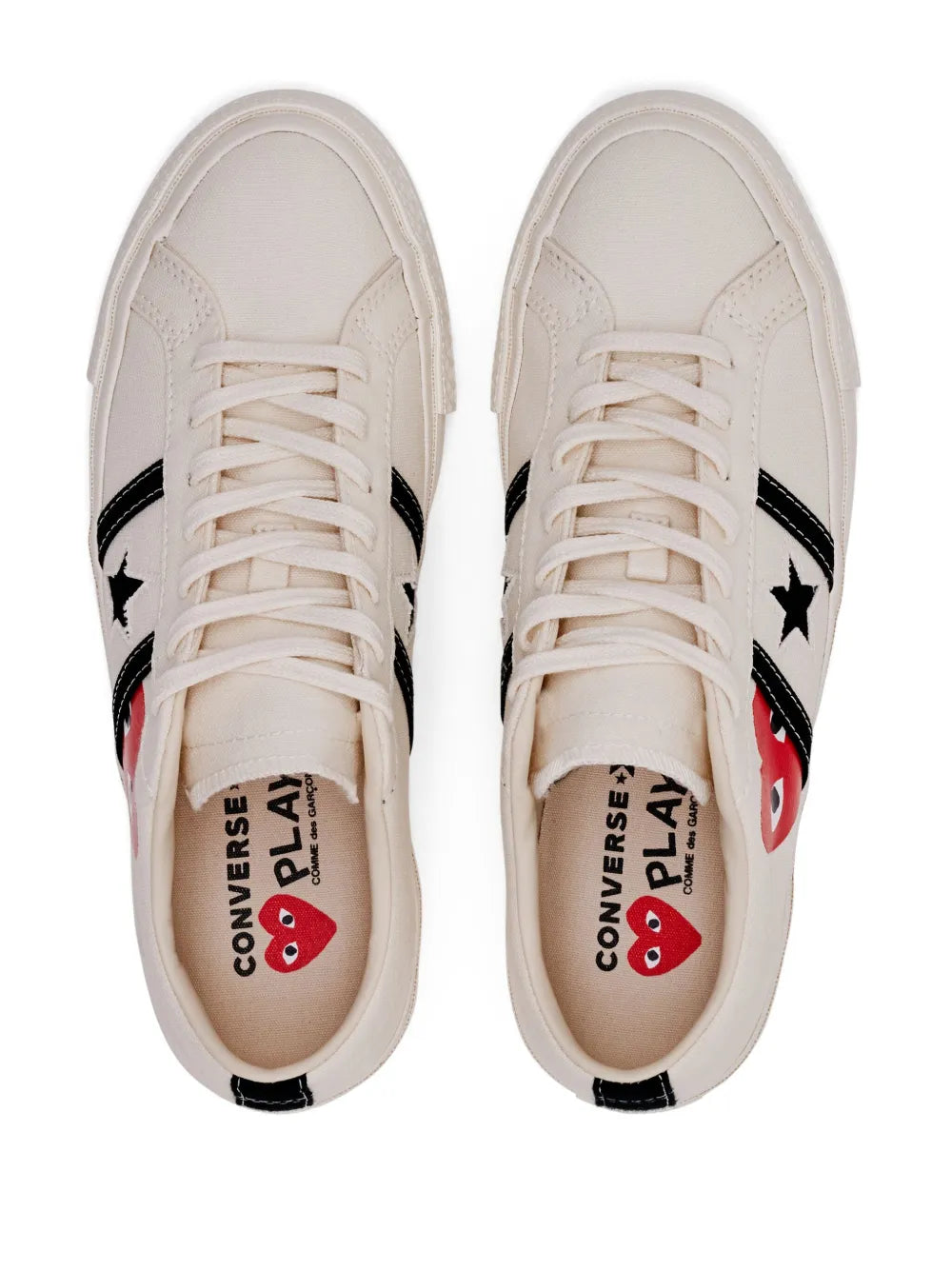 White sneakers showing tongue branding with red eye graphic, lace-up