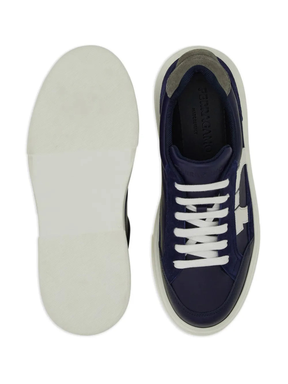 Ferragamo Gancini leather sneakers underside view with white outsole and navy upper