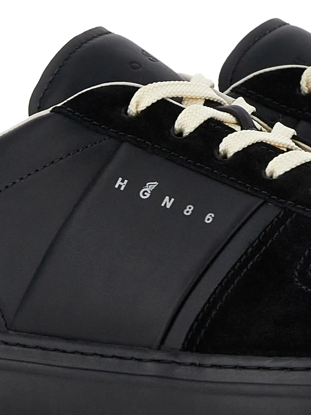 Black leather low-top sneakers close-up with off-white laces and Hogan H668 branding