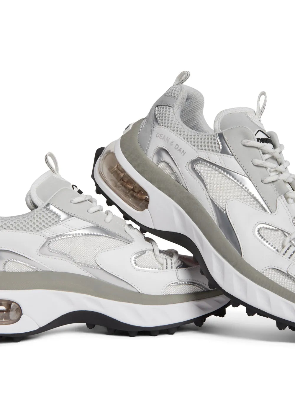 White/grey low-top lace sneakers shown from side, chunky sole with air-bubble detail