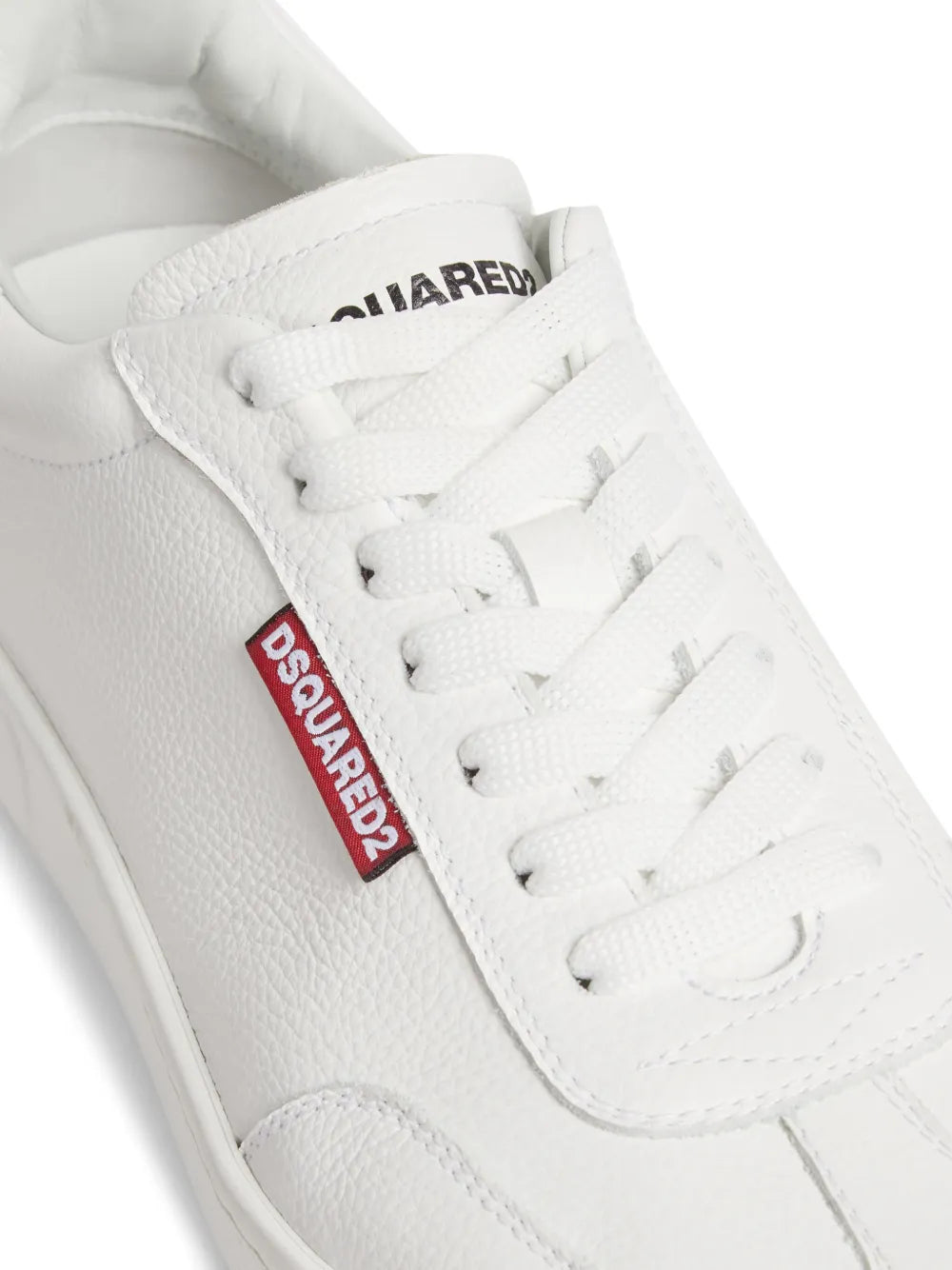 White leather sneaker with Dsquared2 logo-tag on lace panel, close-up