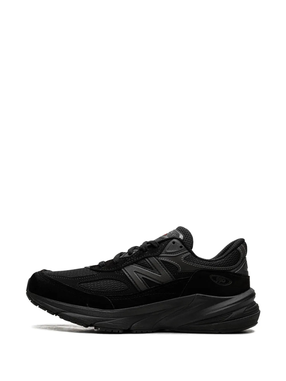 Black New Balance 990V6 mesh sneakers with layered overlays and lace-up closure.