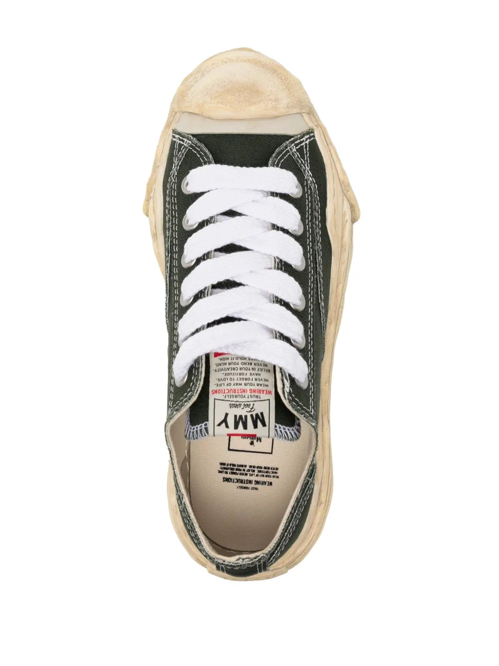 Dark green low-top sneaker top view, white laces and beige interior, label on tongue