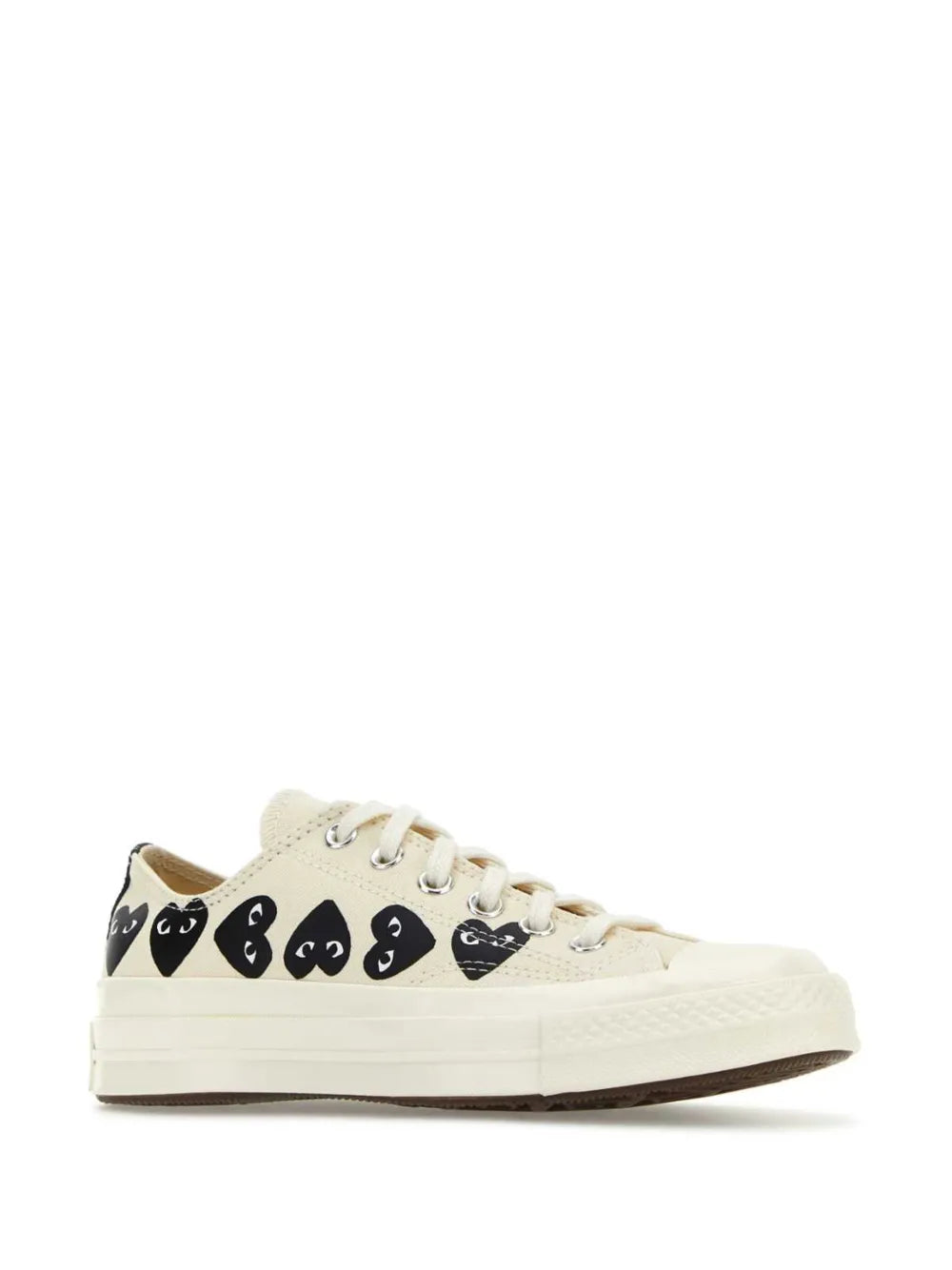 White low-top sneakers with black face graphics on side, lace-up